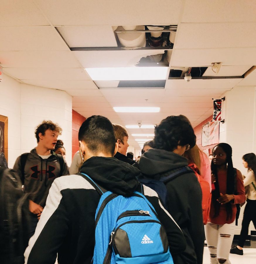 Students walk through the hall after whole school lunch to get to their third block class.