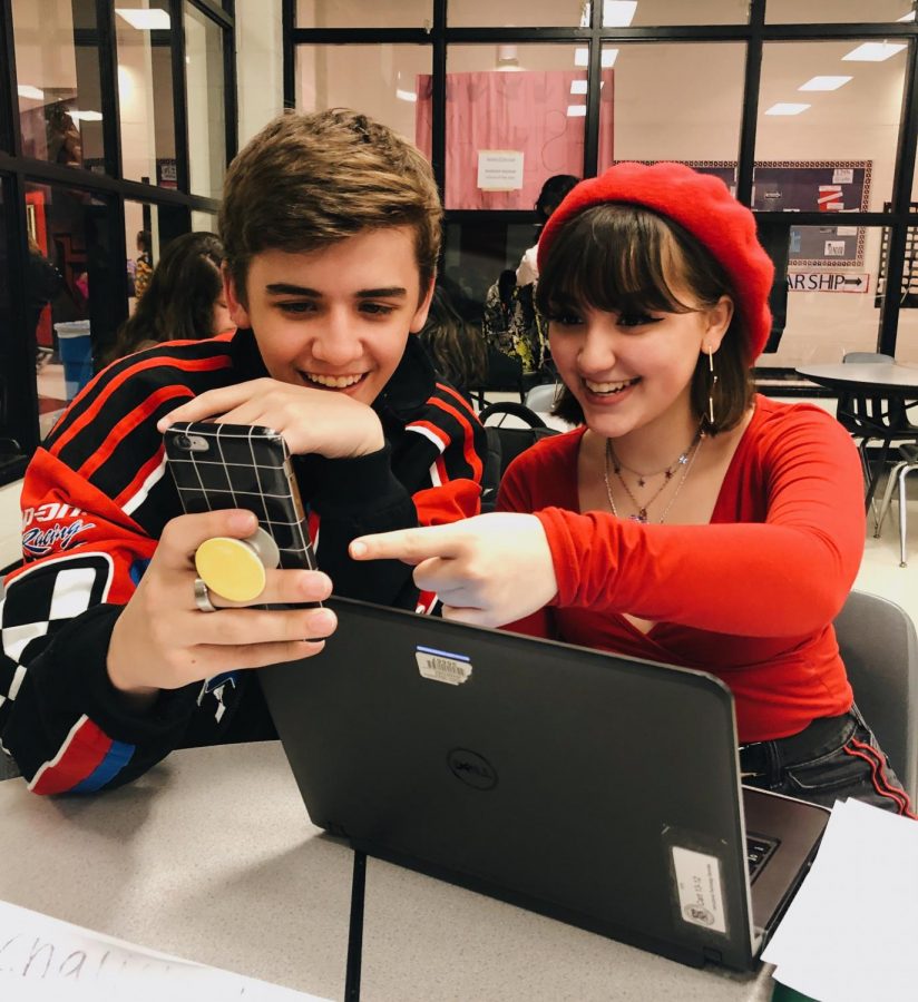Two sophomores, Ryan Benson and Lexi Howard, laugh at a funny video on Ryans phone during study hall.