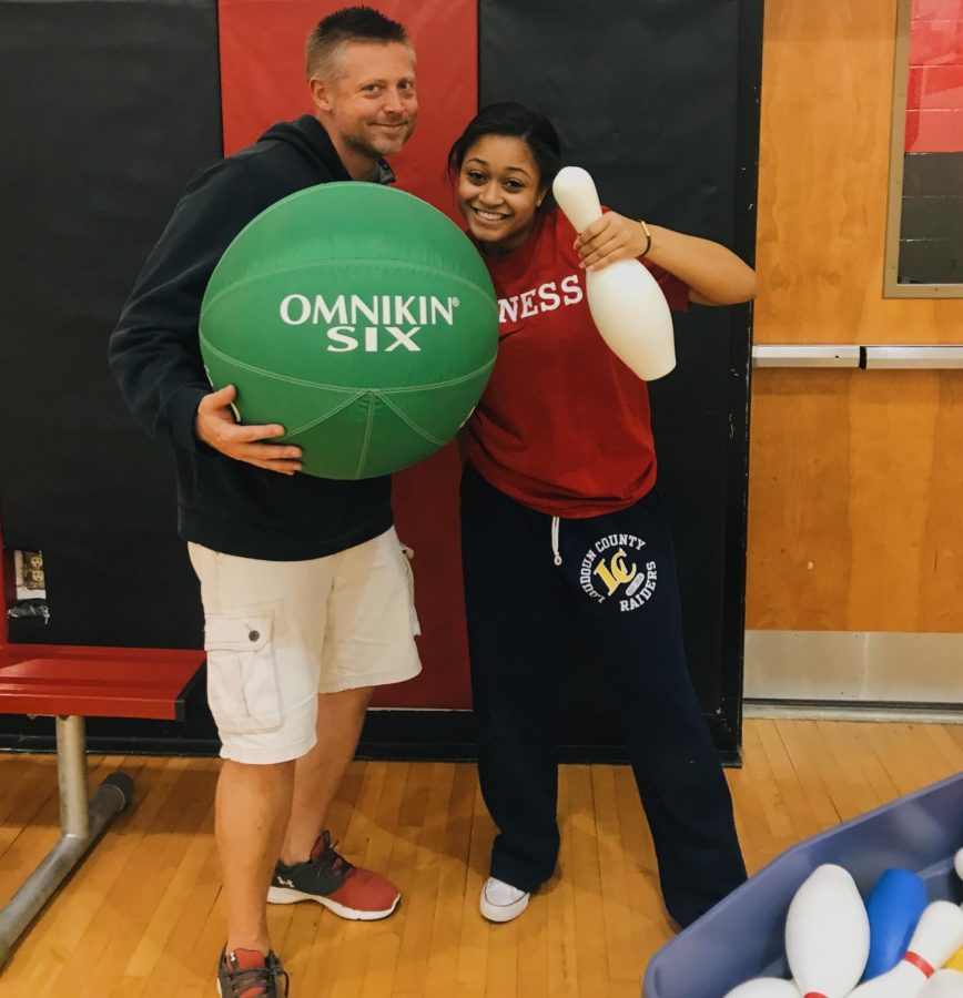 Mr. Boring and Jasmine Davis, sophomore, smile after playing a game in PE.