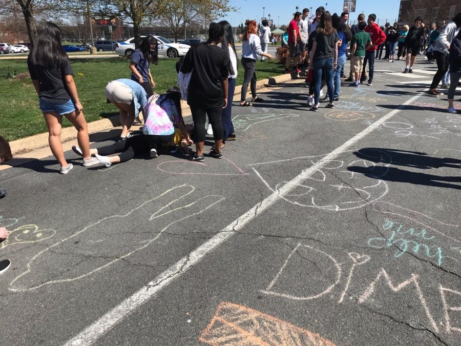 Students begin the Awareness Walk around the school with the chalk station where people wrote or drew positive messages.
